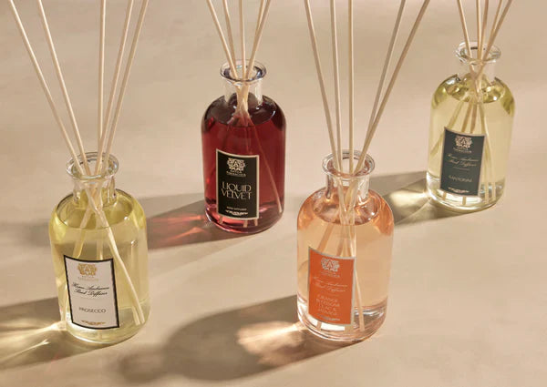 Elegant glass reed diffusers with colored oils, perfect for stylish home décor from DecoDine.
