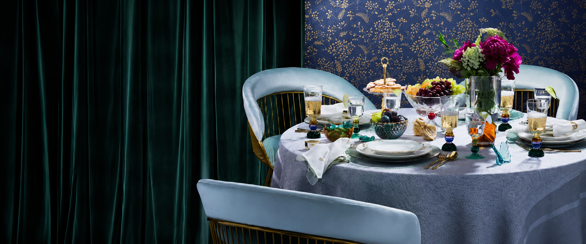 Elegant DecoDine table setting with fine glassware, fruit, flowers, and stylish décor accents
