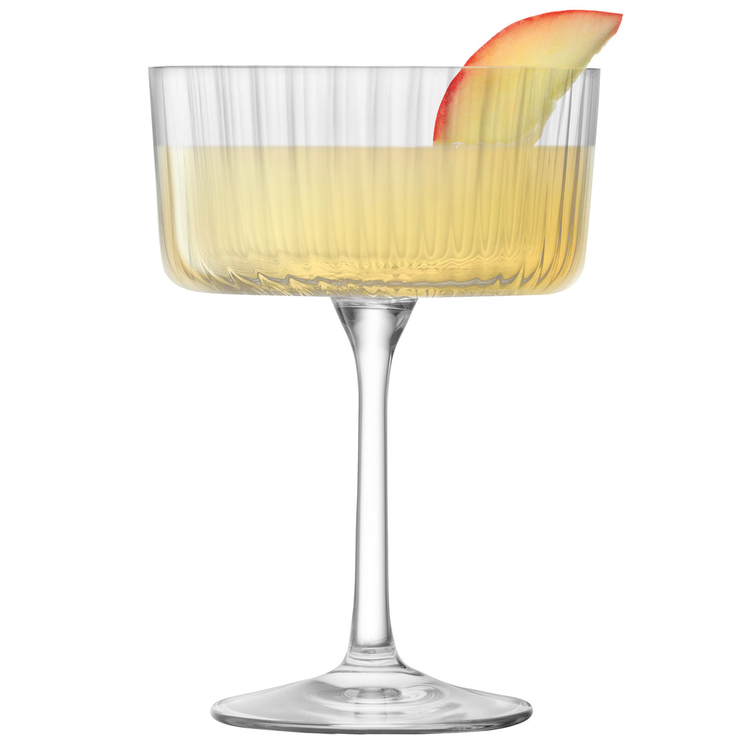 Elegant champagne cocktail glass with light drink and apple garnish, DecoDine home décor